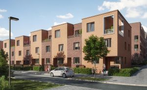 Moderne Reihenhäuser aus rotem Backstein, 3–4 Stockwerke, mit Balkonen, Bäumen, gepflasterter Straße und einem weißen Auto.