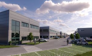 Modernes Gewerbegebiet mit mehrstöckigen Bürogebäuden, Parkplätzen, gepflasterten Wegen und Bäumen unter bewölktem Himmel.