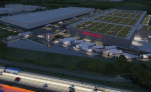 Luftbild-Rendering eines Rossmann-Logistikzentrums bei Nacht mit LKW-Rampen, Parkplätzen und beleuchtetem Firmenlogo.