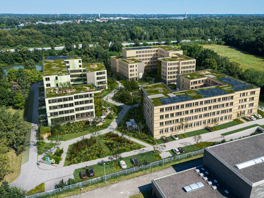 Luftaufnahme eines modernen Gebäudekomplexes mit Gründächern, umgeben von Grünanlagen, Wegen und Bäumen.