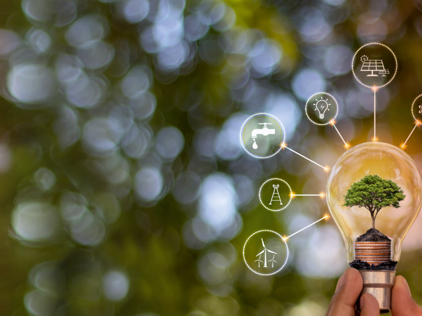 Hand hält Glühbirne mit Baum darin; drumherum Icons für Wasser, Wind, Solar und Strom auf grünem Hintergrund.