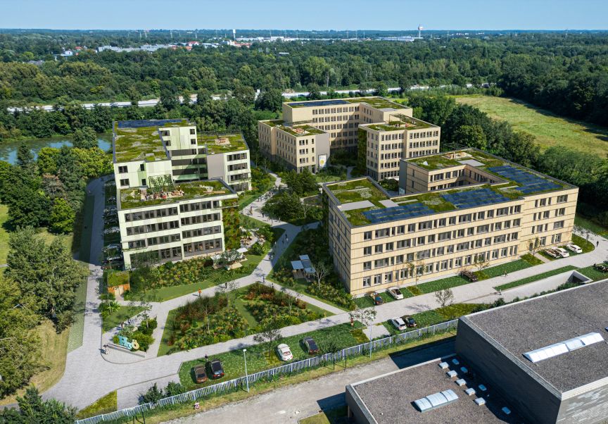 Luftaufnahme eines modernen Gebäudekomplexes mit Gründächern, umgeben von Grünanlagen, Wegen und Bäumen.